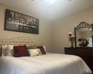King sleep number bed with backboard, dresser, side table, print, pillows and matching decor