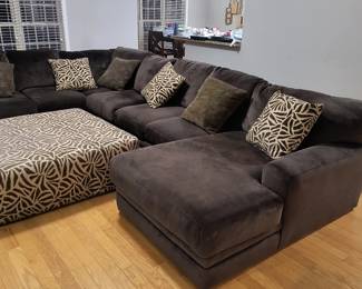 Large sectional with ottoman and pillows.