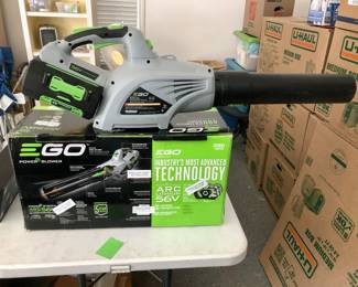 Blower, mower, and batteries sold together