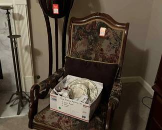 Antique sewing rocker, hand carved mahonogy swan plant stand with greenery, candle sticks, clocks