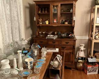 Maple hutch 1970, maple dining room table with 2 chairs and decons bench early 1960's. Pig chalk board, crystal items, amber glass, carvinal glass, vintage honey pots, wine glasses, hen on nest, murano art glass swan, vintage plates, blue willow sugar and creamer, green glass, blue glass and clear candy/powder boxes, etc