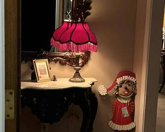 Entry table and mirror. Victorian style lamp, Pot girl elf wall hanging.