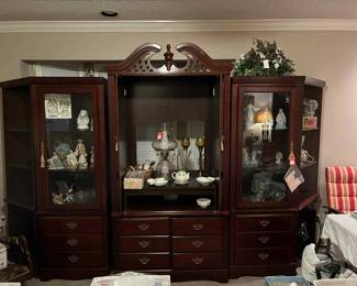 Very nice 5 piece entertainment center with glass shelves and lights. Fenton pink glass lamp, vintage copper bugle sconts with orginal globes, crystal, figurines, Nikon film camera, perfume