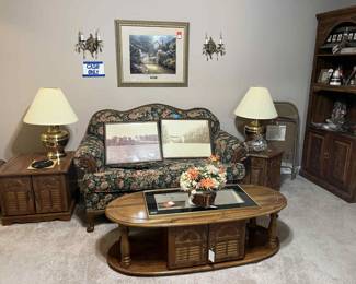 Broyhill 1980's camel back oak trim love seat. Brass lamps, Thomas Kincaid Library edition framed print. Coffee table, end tables, leg massage machine, pine 1976 bookcases with light, Indian decor.