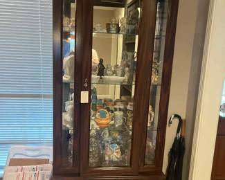 Cuiro cabined with glass shelves and light in top and bottom. Figurines, 50th anniversary items, made in Brazil vintage figurines (old fair prizes), vintages planters, beer stines, etc
