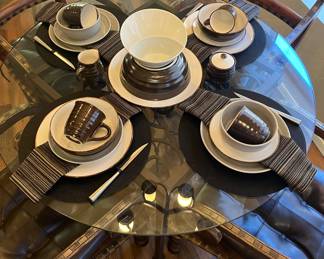 Several different styles of dinnerware, table linens, flatware and glassware