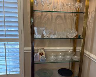 Gorgeous brass and glass display shelving with a lot of Lalique