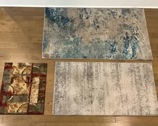 Three Varied Size And Colored Rugs