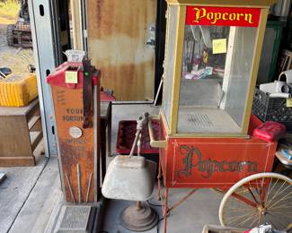 Popcorn machine, antique tanning light, and an antique guess your weight and your date of birth And your fortune scale