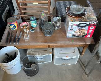 Some Tupperware‘s a bucket of steak knives some terrariums a pressure cooker couple of old tins one Ritz crackers, tin, and a Hershey’s kiss tin coffee table and antique chair