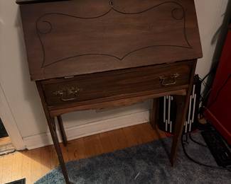 Slant top desk and brass lamp