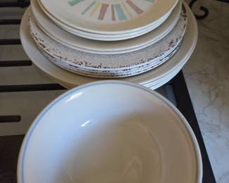 Collection of vintage stoneware including patterned salad plates, rustic crackle-finish dinner plates, and a classic white bowl with a blue trim. Perfect for eclectic table settings, daily use, or adding nostalgic charm to your kitchenware.