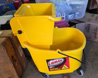 Heavy-duty rolling mop bucket with built-in wringer and "Caution Wet Floor" label. Great for janitorial use, garage cleanups, or large household jobs.