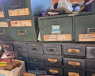 Heavy-duty steel storage units with labeled drawers for organizing tools, hardware, and accessories. Perfect for garage workspaces or collectors of industrial-style storage.