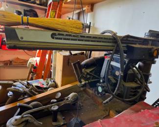 Heavy-duty radial arm saw from Craftsman paired with a set of classic wood hand planes. Perfect for precision crosscuts and traditional woodworking in a well-equipped shop.