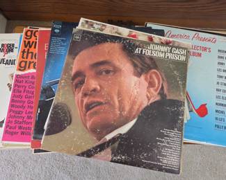 Collection of Vintage Vinyl Records Featuring Johnny Cash and Other Classics - Ideal for collectors or fans of classic Americana and vintage audio formats.