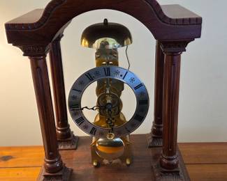 Mantel Clock with Roman Numerals and Exposed Mechanism - A pendulum hangs beneath, contributing to its vintage charm and mechanical elegance.