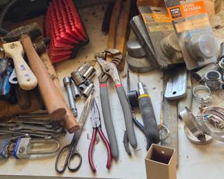 Mixed collection of tools including wrenches, pliers, screwdrivers, hammers, and miscellaneous hardware. Ideal for garage tinkerers or anyone looking to build up their toolkit.
