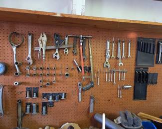 Pegboard-mounted tool system featuring a wide variety of wrenches, sockets, pliers, and specialty hand tools. Ideal for keeping a workshop organized and tools easily accessible.