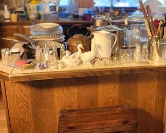 Rustic Stool. Vintage Ceramic Ducks, Pitcher, Sock Pot, Salt and Pepper Shakers, Utensils, CocaCola Glasses, Cookware, Pie pans, Clear Cannisters.