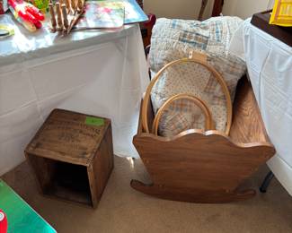 Crate, embroidery hoops, quilt, wooden cradle