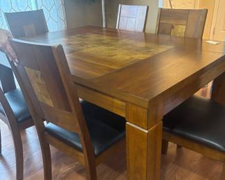 Dining room table with six chairs and one leaf