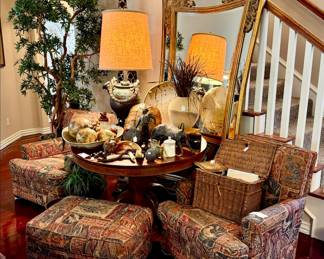 CLUB CHAIRS, ANTIQUE OAK TABLE FULL OF ECLECTIC DECOR.