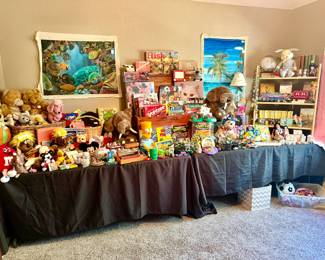 KID'S WALL WITH VINTAGE AND MODERN GAMES, TEENAGE MUTANT NINJA TURTLES, STUFFED ANIMALS, BOOKS, AND MORE.