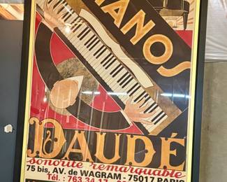 Title: "PIANOS DAUDÉ"
Design: A diagonal placement of a piano, with an overhead view of a pianist's hands on the keys.
Location: The piano store was located at 75 bis, Avenue de Wagram in Paris, France.
