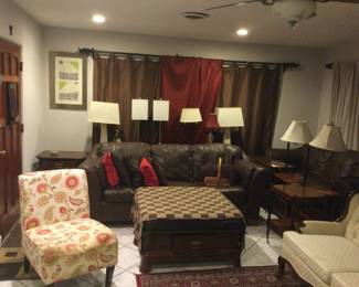 Leather sofas, floral chair, ottoman with drawer, lamps and end tables
