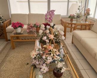 Rattan sofa's and tables and assorted floral arrangements