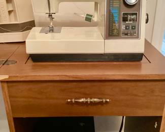 Singer sewing machine in cabinet