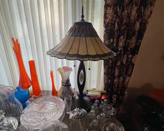 . . . stained-glass lamp and orange art-glass vases