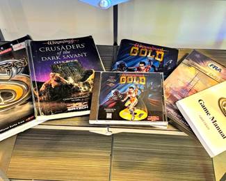 Vintage computer game boxes and manuals, primarily from the Wizardry series.