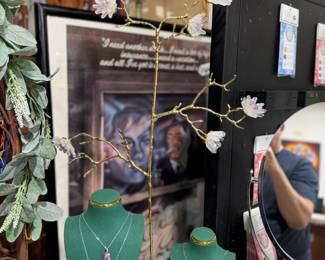Gemstone Necklaces, Quartz, Amethyst and metal jewelry tree, vintage poster in frame.