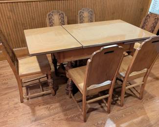 $500 - VTG Eastlake Carved Oak Dining Table and Six Matching Hall Chairs, c1920s, A+ Condition, (enamel porcelain top likely associated). Table Length: 61 ¾ in.; width: 31 ¾ in.; height: 30 ½ in.; Chair width: 16 ⅝ in.; depth: 16 in.; height: 37 in.; seat height: 18 ¼ in. For more photos see: https://www.facebook.com/marketplace/item/1862213334701381/