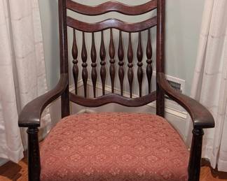 $100 Victorian Rocking Chair, circa 1880s
Dark stained wood, with open arms, back with pressed shell design above spindle back, over upholstered seat covered in tan and rust red fabric finished with embossed brass medallions.
Width: 25 ½ in.; height: 45 in.; depth of rocker blades: 34 ½ in.