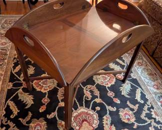 $50 American Mahogany Butler’s Tray Top Coffee Table
Early 1980s
Of traditional form with four hinged leaves with pierced handles; raised on straight legs joined by X-stretcher.
29 x 20 ½ x height: 19 in.; demilune leaves width: 5 in.