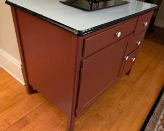 $25 Hoosier Baker’s Cabinet with White Enamel Top
The red painted cabinet with compartmented drawer for utensils; two storage drawers and one metal lined bread drawer; the cabinet door opening to original interior with metal cooling rack.
39 ½ x 25 x height: 30 ½ in.