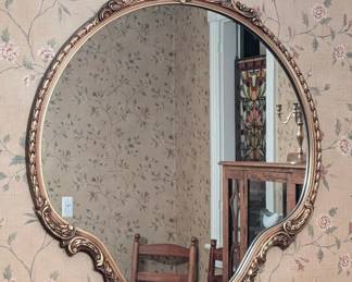 $50 Giltwood Mirror, mid 20th Century
Of circular cartouche form, the top with oval medallion surrounded by overlapping scrolls leading to garland border, cartouche mirror plate, the bottom with flower carved giltwood frame. Note: 4-inch black blemish in the mirror plate.
35 x 29 ¼ in.
