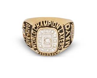 2029
A Los Angeles Lakers Custom 1988 Championship 14K Gold and Diamond ring
A commemorative "World Championship Lakers 1988" ring featuring a central round diamond surrounded by twelve smaller diamonds, with "Back-2-Back" and enameled NBA team logo to one shoulder, and with "Mayo" and "Lakers 4 Pistons 3" to opposite shoulder, marked for 14K gold, and for Balfour ©
Size: 7
17.3 grams gross
Diamonds: color: G-H; clarity: VS-I
Estimate: $1,500 - $2,500