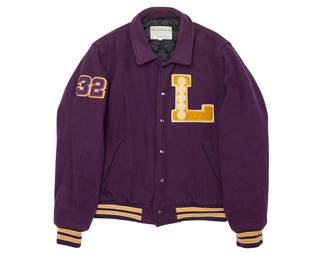 2030
A Vintage Lakers Varsity Jacket - Magic Johnson No. 32
Late 20th century
Label: Forum Promotions, Inc. / Made in Korea / M
The purple wool-mix snap-front bomber-style jacket with yellow "L " applique letter patch with five basketball motifs and no. 32 patch to right sleeve and Lakers logo to back, with purple and yellow striped rib cuffs and waist, with quilted black nylon lining
Size M; chest: 24 " (across front); Center back: 26"; sleeve: 26"
Estimate: $100 - $200