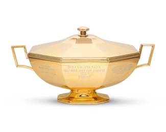 2067
1987
A Hollywood Park "Gold Cup Handicap" horse racing trophy
Marked to underside: St. James / Made in Brazil; exterior inscribed: Hollywood Park / Hollywood Gold Cup Handicap / (Grad I) / Won by / Ferdinand / June 28, 1987 / One Mile 8 One Fourth / Purse: $500,000 Guaranteed / Owner: Mrs. Howard B. Keck / Trainer: Charles Whittingham / Jockey: William Shoemaker / Time: 2:00:3
The gold-plated silver alloy lidded trophy with opposed handles
10.5" H x 18.875" W x 10.125" D
Estimate: $1,500 - $2,000
