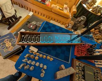 This blue case covered is the vintage Austin Cox aluminum chess set. Very unusual and highly coveted.