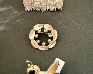 Brooches, including silver "Bats" (top) and grasshopper (bottom)