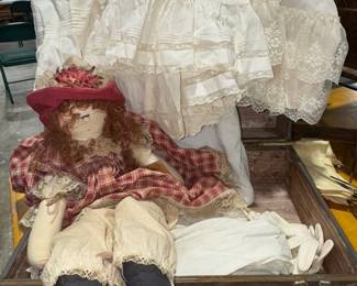 Doll, linens, suitcase