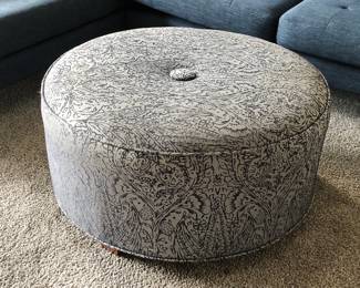 Paisley print upholstered round ottoman