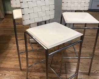 Set of three white woven-back counter stools