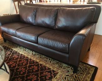 Three-cushion dark brown leather sofa in excellent condition