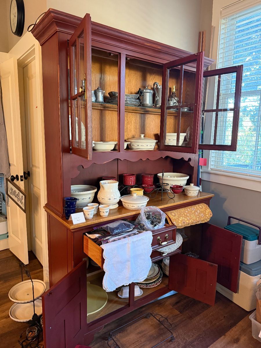 Farmhouse buffet with hutch houses a large collection of Longaberger pottery and Armetale pewter.